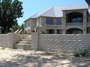 Erosion control is the main objective of a concrete retaining wall. This one is next to a sandy beach. Steps down to access the beach front.